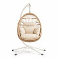 Sedia sospesa in rattan sintetico con cuscini beige e supporto in metallo